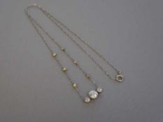 A platinum and diamond pendant on chain