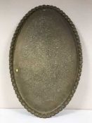 A large engraved copper scalloped edged tray,