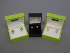 Three pairs of pearl earrings set in gold, one 18ct.