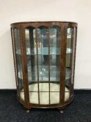 A walnut d-shaped display cabinet