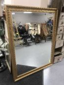 A large gilt framed over mantel mirror
