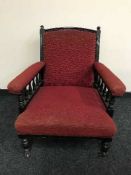 A Victorian armchair upholstered in red fabric