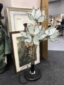 A four way floor lamp with glass flower shades and two framed prints