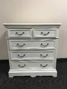 A painted white five drawer chest and a kitchen stool
