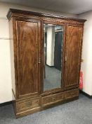 A Victorian inlaid mahogany triple door wardrobe