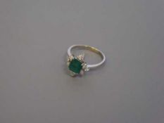 An 18ct gold emerald and diamond ring