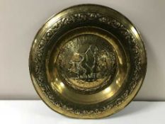 A early 20th century brass embossed charger
