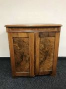 An early 20th century walnut serving cabinet