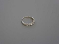 An 18ct white gold seven stone diamond half eternity ring, 2.7g, size M.