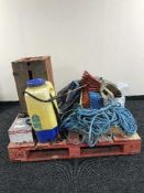 A pallet of battery charger, garden sprayer, wooden crates, laser grease gun, brush heads,