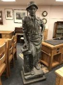 A life-size bronze statue depicting a blacksmith with hammer