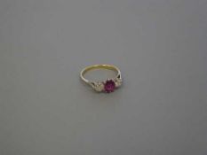 An 18ct gold three stone diamond and ruby ring