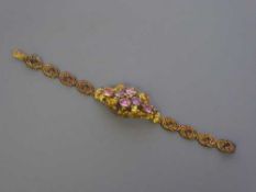 A Georgian gold cuff bracelet set with pink sapphires and emeralds, length 17.5 cm, 14.8g.