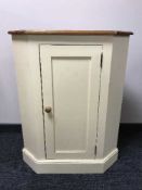 A painted pine corner cabinet