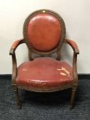 A pair of mahogany framed salon armchairs upholstered in red leather