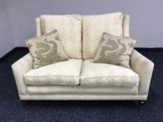 A two seater Duresta settee in yellow fabric
