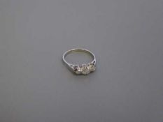 A platinum three stone diamond ring