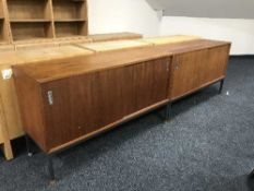 A pair of late 20th century teak sliding door cupboards