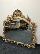 An ornate gilt framed Rococo style mirror