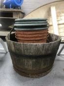 A metal bound oak barrel planter and quantity of plastic plant pots