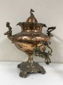An antique copper and brass Samovar with stags head handles