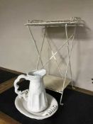 A pottery jug and basin and a metal folding wash stand
