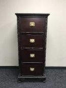 A carved mahogany four drawer filing chest on claw & ball feet with inset green leather panel