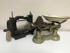 An early 20th century had sewing machine, vintage kitchen scales and weights,
