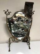 An antique leather gun slip and a mirrored etched shield fire screen