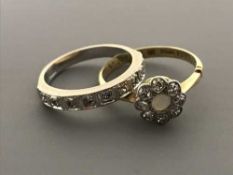 A white gold diamond half eternity ring and an 18ct gold diamond and opal cluster ring