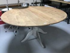 A pine pedestal table with an Ercol top