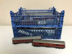 A collection of early tin plate railway carriages and a crate of assorted rolling stock