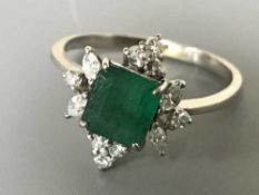 An 18ct gold emerald and diamond ring