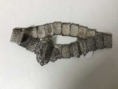 An ornate Eastern white metal belt