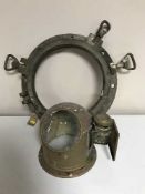 A brass porthole and a copper binnacle cover