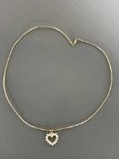 An 18ct gold diamond set heart pendant on chain, the total diamond weight approximately 1.