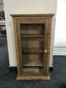 A pine glazed door curio cabinet