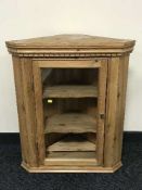 A pine glazed door hanging corner cabinet