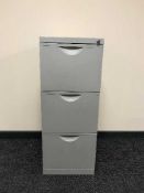A three drawer metal filing cabinet with key