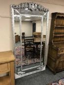 A large contemporary silvered floor standing mirror,