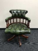 A green button leather Chesterfield swivel armchair
