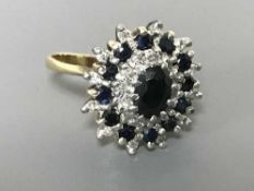 An 18ct gold diamond and sapphire cluster ring, size P, 7.8g.