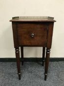 A Victorian mahogany pot cupboard on turned legs