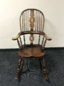 An oak Windsor style rocking chair