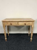 A pine side table fitted two drawers