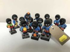 A tray of fourteen Robertson golly figures - footballers and band players