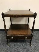 A Regency style mahogany two tier lamp table
