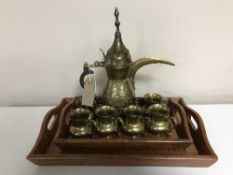 Two brass inlaid Indian trays together with an Indian brass teapot and six brass cups