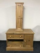 A pine entertainment unit and a pine sentry door cabinet