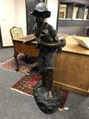 A patinated bronze fountain statue depicting a fishing boy